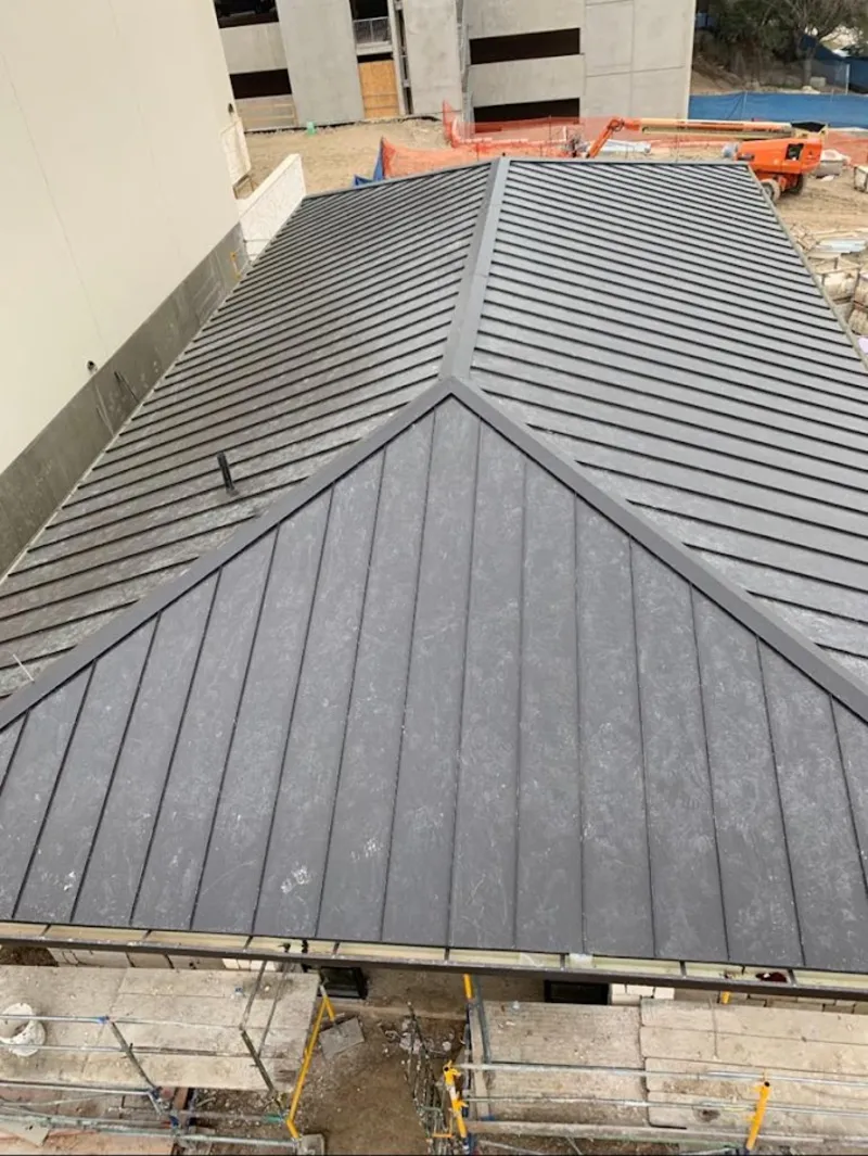 Commercial metal roof construction with crane equipment in Broadview Park