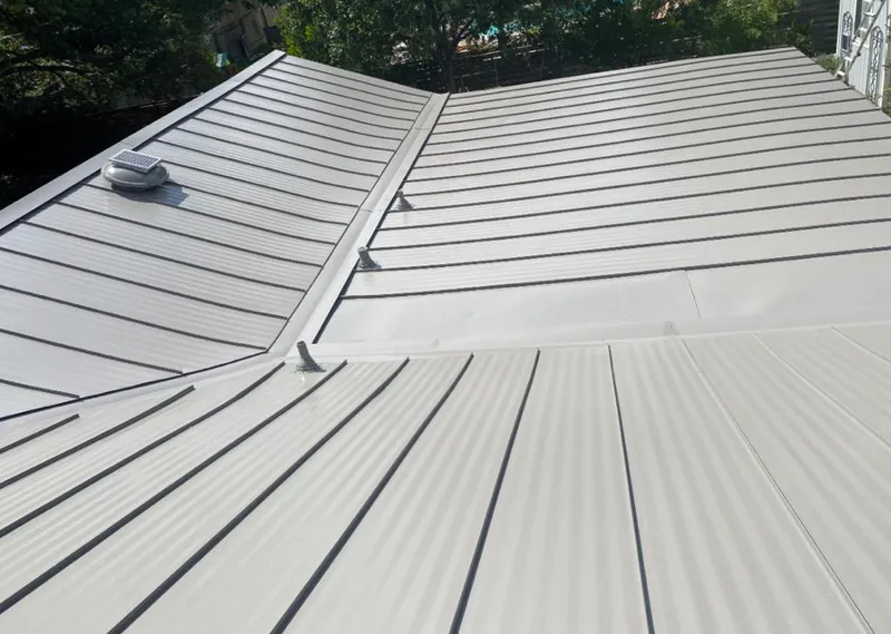 Solar attic fan installed on a metal roof for Roof Ventilation in Broadview Park